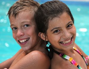 cousins enjoying swimming at the hotel