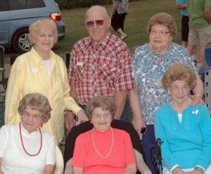 Vila is the lady front and center in the coral colored shirt